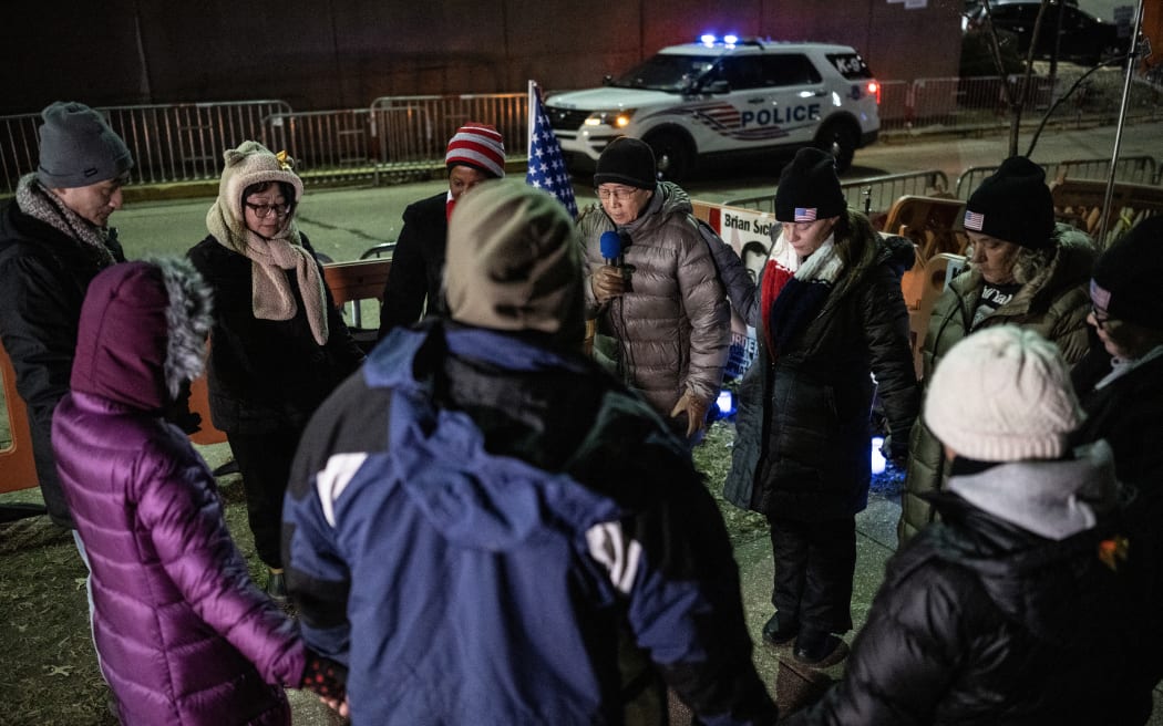 People pray at a vigil in support of January 6th defendants outside the Washington DC Central Jail, on 3 January, 2024.