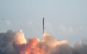 SpaceX's Starship rocket lifts off from Starbase, Texas, as seen from South Padre Island on August 26, 2025, for its tenth test flight. SpaceX's Starship megarocket roared into the skies Tuesday on its 10th test flight, following a string of explosive failures that cast doubt about its ability to realize Elon Musk's vision of colonizing Mars. (Photo by RONALDO SCHEMIDT / AFP)
