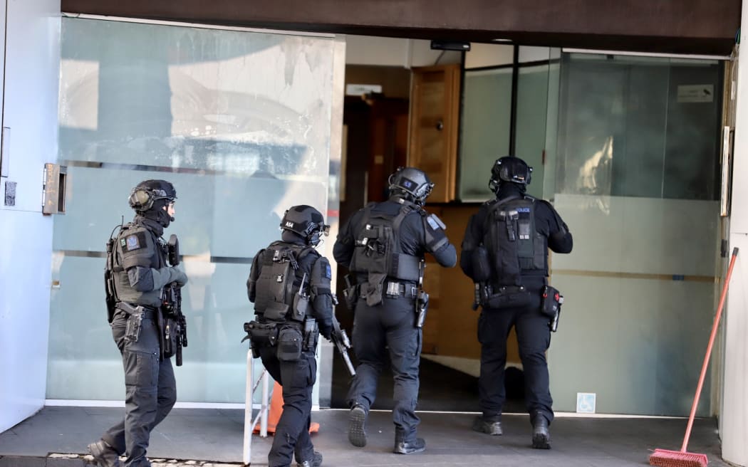 A SWAT team enter a building on Hobson Street after reports of a person with a gun
