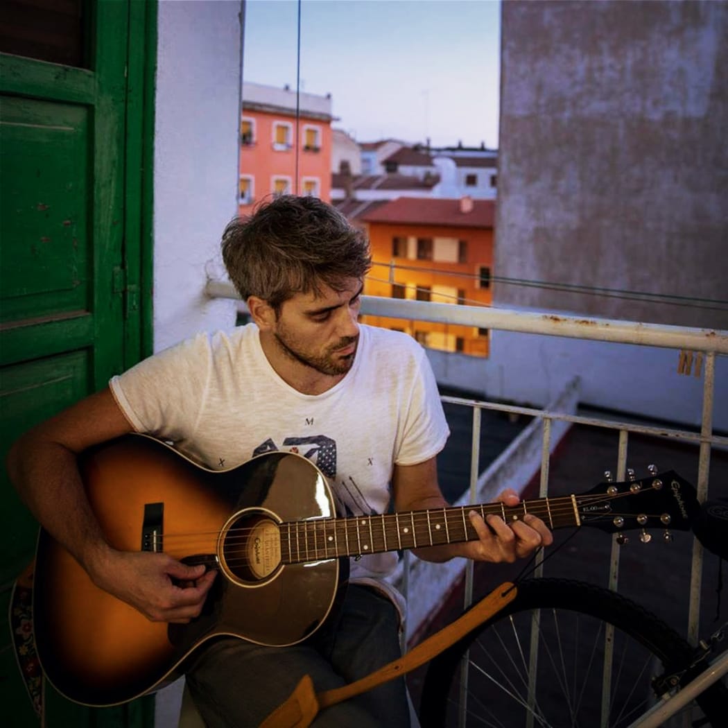Johnny Barker playing his guitar
