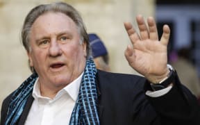 (FILES) French actor Gerard Depardieu waves as he arrives at the Town Hall in Brussels for a ceremony as part of the 'Brussels International Film Festival' (Briff) on June 25, 2018. French police summoned Depardieu over suspected sexual assault, a police source said on April 29, 2024. Depardieu already faces a rape charge and sexual assault investigation, as well as claims of assault by more than a dozen women -- all of which he has strongly denied. (Photo by THIERRY ROGE / BELGA / AFP) / Belgium OUT