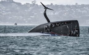 American Magic capsized just before the final leg in race three of the Prada Cup.