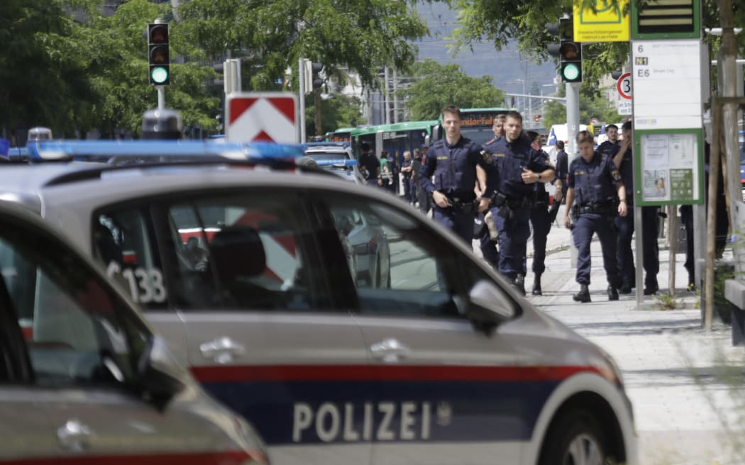 Police walk near a school where several people died in a shooting, on June 10, 2025 in Graz, southeastern Austria. Ten people died after a suspected shooter opened fire in a southeastern Austrian school, press agency APA quoted Graz city mayor Elke Kahr as saying. Several students and at least one adult are among those killed, Kahr confirmed to APA. (Photo by Alex HALADA / AFP)