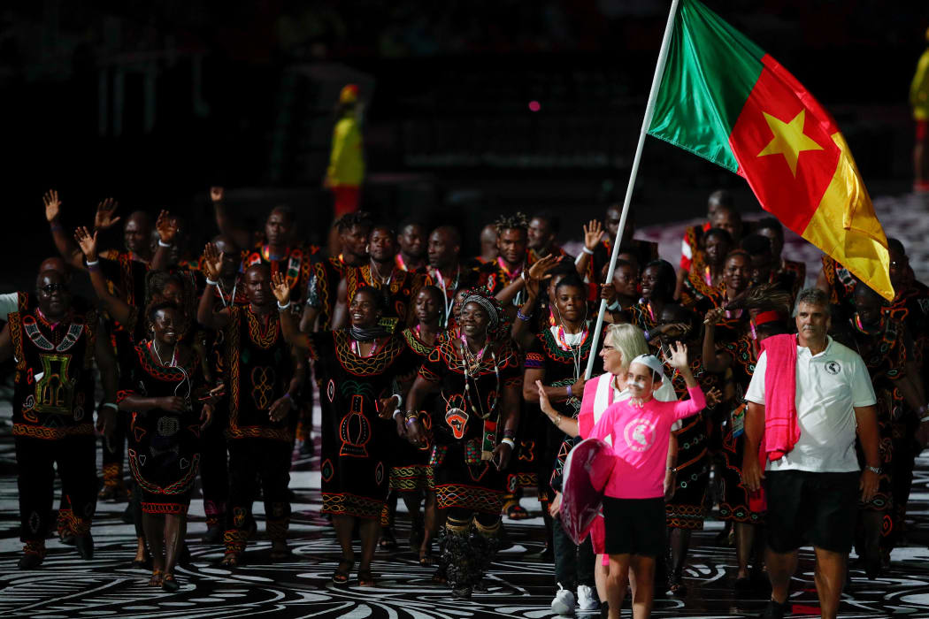 Cameroon's flagbearer Essiane Clotilde leads the delegation during the opening ceremony of the 2018 Gold Coast Commonwealth Games at the Carrara Stadium on the Gold Coast on April 4, 2018.