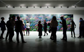 Visitors to the opening of 'Solo' look at 'Hydrangeas' by Karl Maughan.