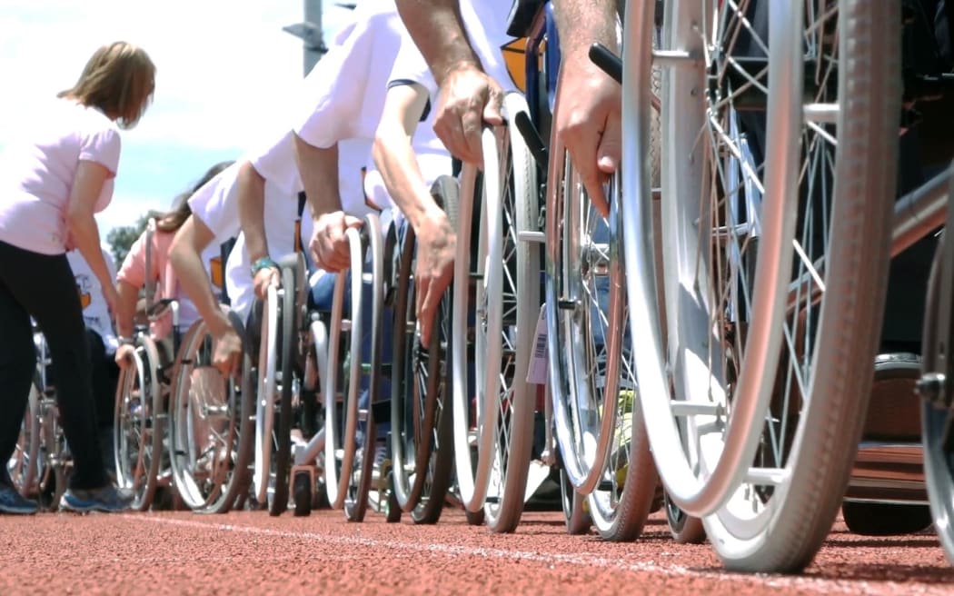 The line-up of participants trying to break the record for the longest moving line of wheelchairs.
