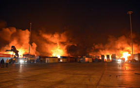 Firefighters battle the blaze at Syria's Latakia port after an Israeli air strike.
