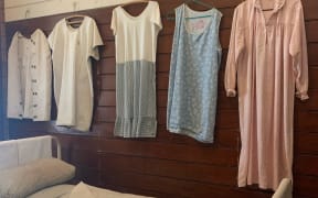 Vintage women's clothing and hospital bed at Porirua Hospital Museum