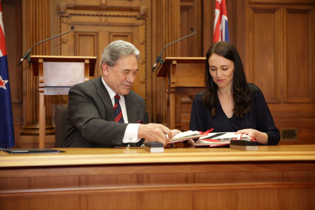 Jacinda Ardern and Winston Peters signing the coalition agreement.