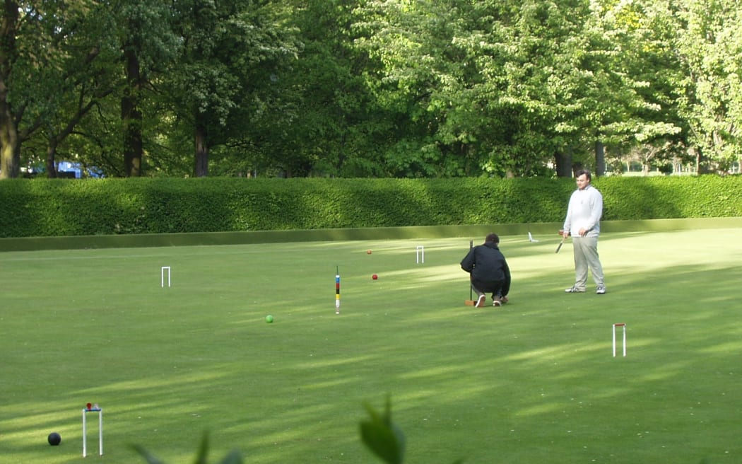 Croquet players on their lawn