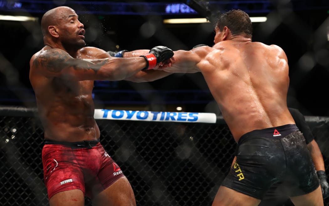 Paulo Costa throws a punch at Yoel Romero in the third round during their Middleweight Bout at UFC 241 at Honda Center on August 17, 2019 in Anaheim, California.