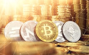 Bitcoin, Dash, Ripple, Monero, Litecoin and blockchain nodes in blurry closeup against lots of golden coin piles. Cryptocurrency meaning on global market growth concept. 3D rendering