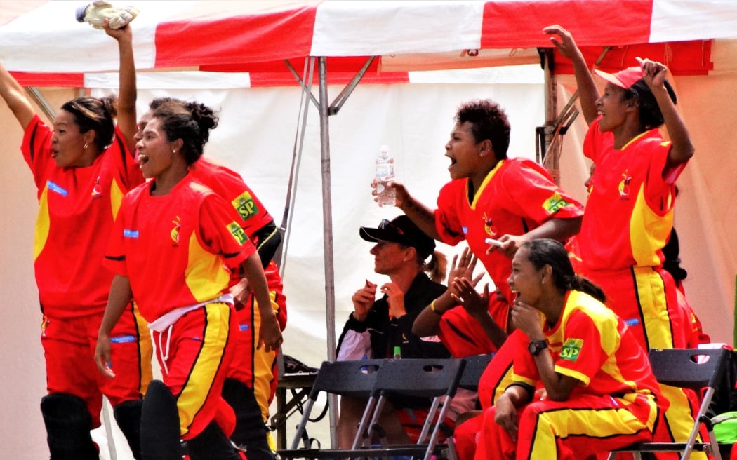 PNG players celebrate the winning runs.