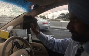 Balkar Singh holds the rock that was thrown from a motorway overbridge into his car.
