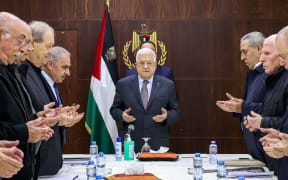 This handout picture provided by the Palestinian Authority's press office (PPO) shows Palestinian president Mahmud Abbas (C) and members of the executive committee of the Palestine Liberation Organisation (PLO) reciting a prayer before their meeting in the city of Ramallah in the occupied West Bank on December 25, 2023. (Photo by Thaer GHANAIM / PPO / AFP) / === RESTRICTED TO EDITORIAL USE - MANDATORY CREDIT "AFP PHOTO / HO / PPO " - NO MARKETING NO ADVERTISING CAMPAIGNS - DISTRIBUTED AS A SERVICE TO CLIENTS ===