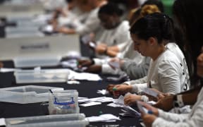 Ballot papers are sorted at the counting centre at Alexandra Palace in London