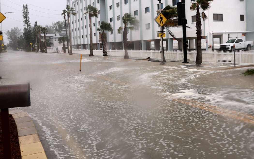 Water from the Gulf of Mexico floods a road as Hurricane Helene, already a Category 3 storm, churns offshore at St Pete Beach, Florida. on 26 September, 2024.
