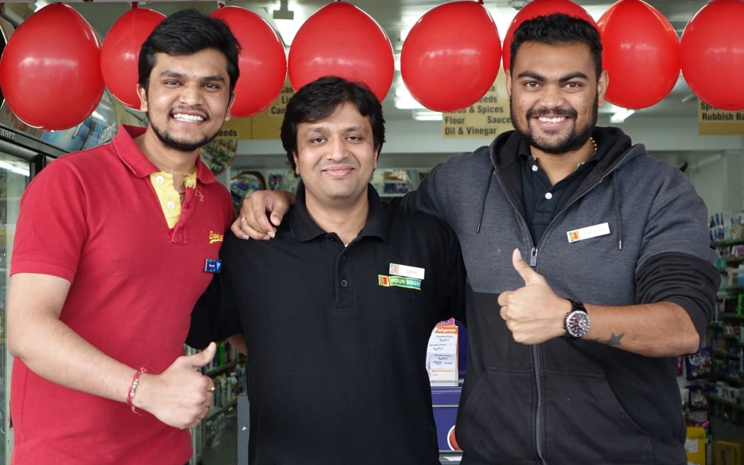 Nimesh Bhavasar, owner Dipak Dubariya, and Peajesh Patel celebrate selling the winning Lotto ticket.