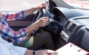 Learning to drive a car with instructor. Driving school.