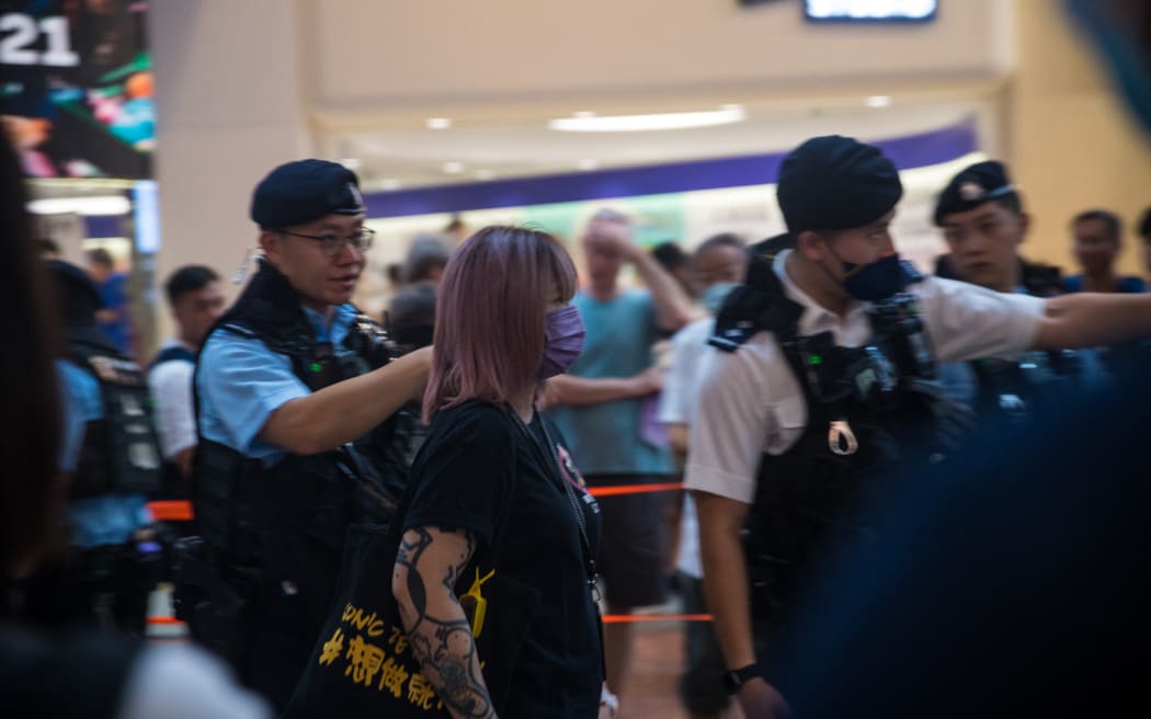 A woman participating in the online media ''Free Hk'' is being detained by the police in Causeway Bay, Hong Kong, China, on June 4, 2023. (Photo by Marc Fernandes/NurPhoto) (Photo by Marc Fernandes / NurPhoto / NurPhoto via AFP)