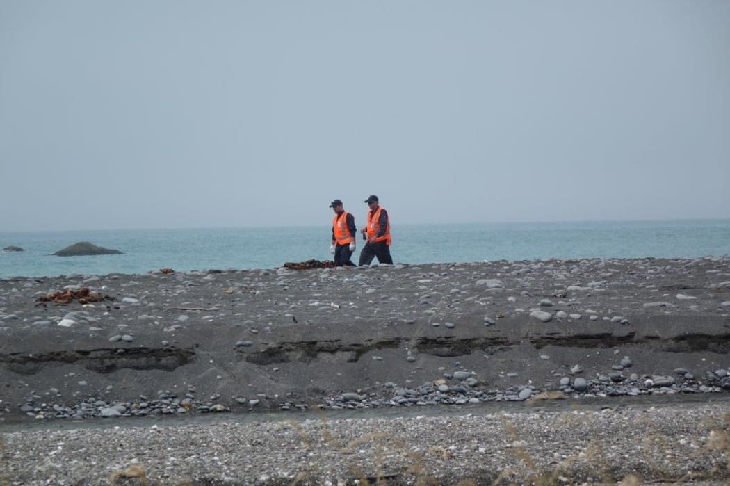 Air crash inspectors comb the scene near the fatal helicopter crash in Kekerengu.