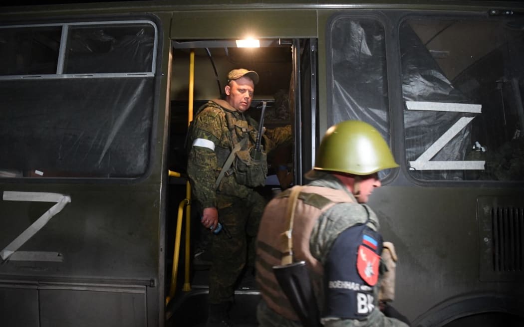 8192515 16.05.2022 DPR's servicemen accompany the bus with the wounded Ukrainian soldiers, in Mariupol, DPR. Russia and Ukraine have reached an agreement on the evacuation of wounded troops from the Azovstal metallurgical plant in Mariupol. A silence regime has been introduced in the area and a humanitarian corridor has been opened through which the wounded Ukrainian troops are delivered to a medical facility in Novoazovsk to provide them with all the necessary assistance Alexey Kudenko / Sputnik (Photo by Alexey Kudenko / Sputnik / Sputnik via AFP)