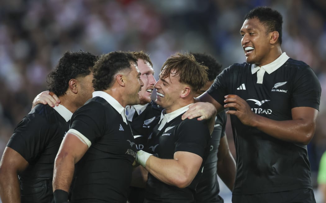 Ruben Love of the All Blacks, centre, celebrates his try with David Havili, left and Samipeni Finau during the All Blacks v Japan.