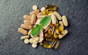 pills and multivitamins  on a black background