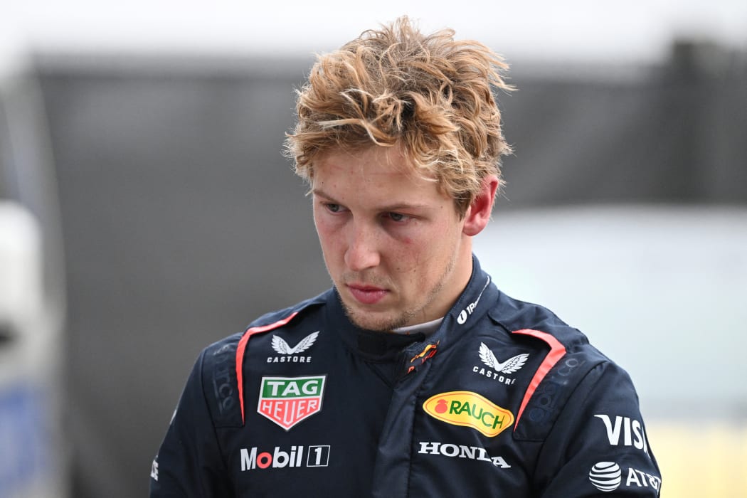 Red Bull Racing's New Zealand driver Liam Lawson walks back to his team garage after getting out of his car at the end of the Formula One Chinese Grand Prix in Shanghai on March 23, 2025. (Photo by GREG BAKER / AFP)