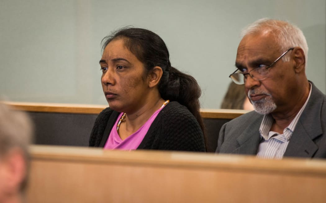 Amandeep Kaur (left) sitting in the dock at the Auckland High Court with a translator (right).