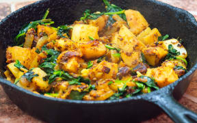 Saag Aloo, Indian style spinach and potatoes in cast iron pan