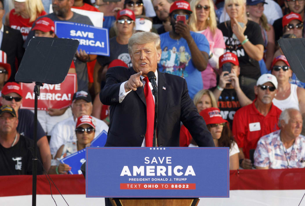 Former President Donald Trump points at the press box speaks of "Fake News" during his campaign-style rally in Wellington, Ohio, on 26 June 2021.