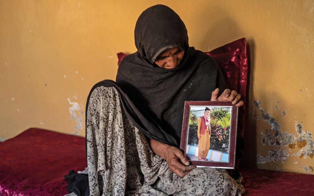 Zar Bibi Hotak shows a picture of her late son Shafiullah Hotak, who died after falling from a US Air Force C-17 aircraft midst the August 2021 panic-stricken evacuation to flee Taliban-led Afghanistan.