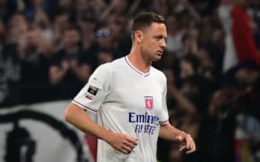 Lyon’s Serbian midfielder Nemanja Matic runs on the pitch with insignia covered up.