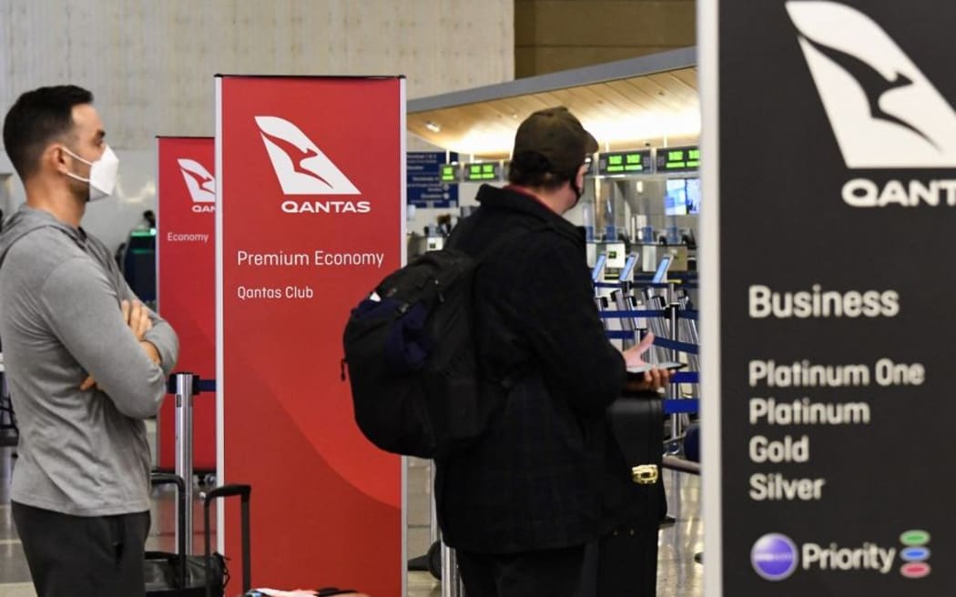 Travelers wait in line check-in for a flight to Sydney, Australia on Qantas Airways Ltd. at (LAX) on November 1, 2021 in Los Angeles, California, as Australia's international border reopens almost 600 days after a pandemic closure began.