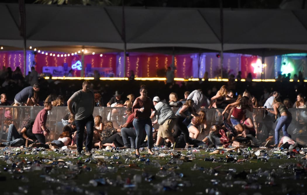 People run from the Route 91 Harvest country music festival.