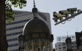 Security cameras are seen on a street in Urumqi, capital of China's Xinjiang region on July 2, 2010. Photo: Peter Parks / AFP