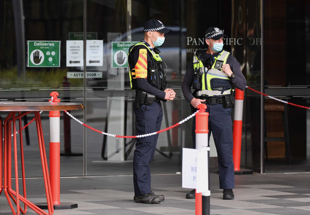 Police stand guard at an MIQ hotel in Melbourne on 7 December 2020.