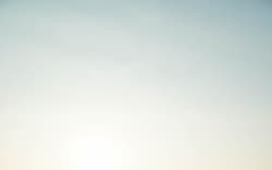 Silhouette of a man jumping on the beach at sunset.
