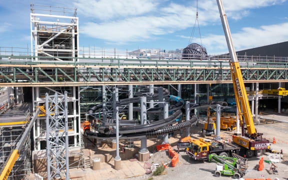 Hydroslides resembling eels being installed at Parakiore Recreation and Sport Centre.