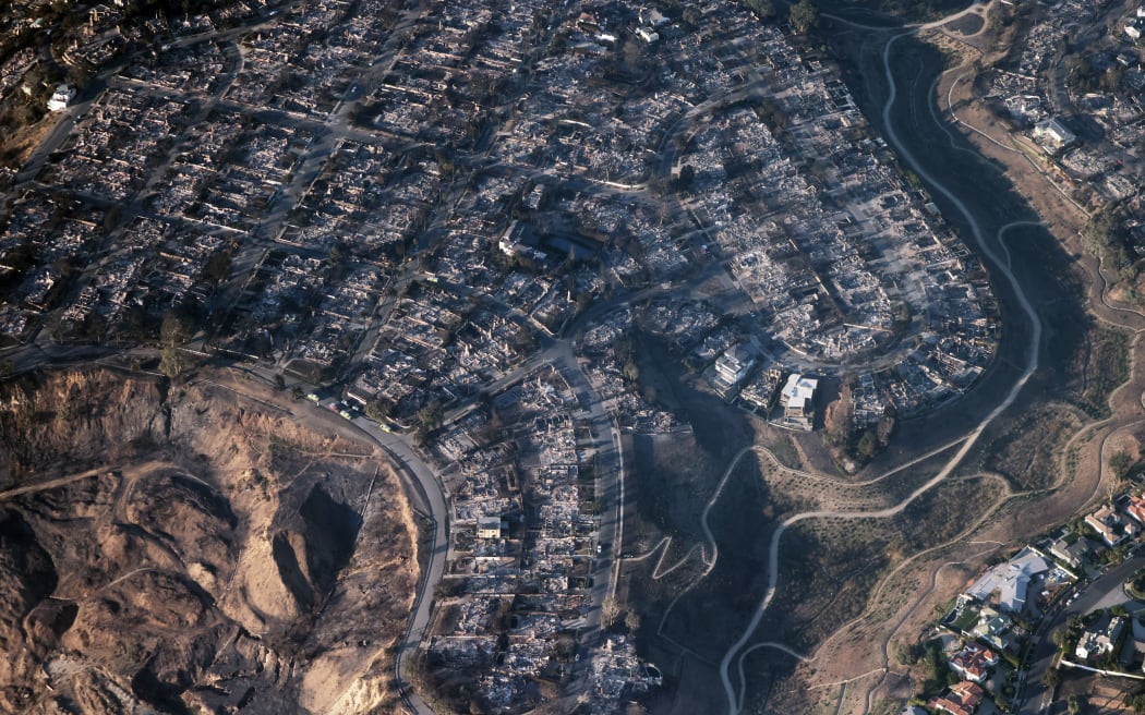 This aerial photo shows homes and businesses reduced to rubble by the Palisades Fire in the Pacific Palisades neighborhood of Los Angeles, California, on January 10, 2025. Massive wildfires that engulfed whole neighborhoods and displaced thousands in Los Angeles have killed at least 10 people, authorities said, as California's National Guard soldiers readied to hit the streets to help quell disorder.
News of the growing toll, announced late Thursday January 9 by the Los Angeles County Medical Examiner, came as swaths of the United States' second-largest city lay in ruins. (Photo by David Swanson / AFP)