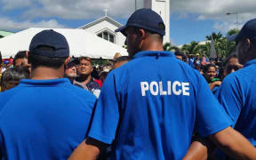 Police keep the crowds at bay during the speeches at today's parade.