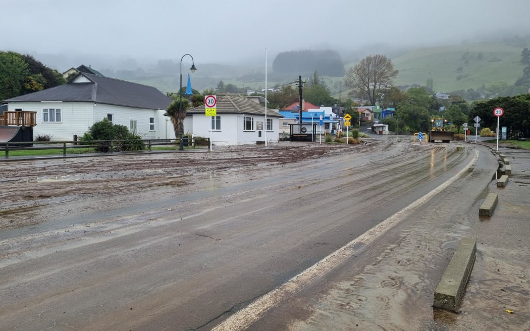 There's thick mud and some debris on the main street in the Dunedin suburb of Macandrew Bay on the Otago Peninsula.