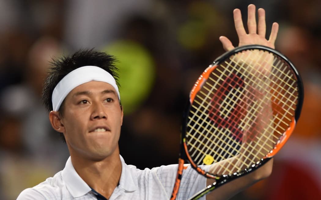 Japan's Kei Nishikori celebrates his win against France's Jo-Wilfried Tsonga on day seven of the 2016 Australian Open in Melbourne, January 24, 2016. AFP PHOTO / GREG WOOD