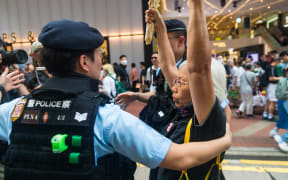 Hong Kong, China, on June 4, 2023, Alexandra Wong (aka ''Grandma Wong'') is being taken in by the police after showing up in Causway Bay with red lillies. (Photo by Marc Fernandes/NurPhoto) (Photo by Marc Fernandes / NurPhoto / NurPhoto via AFP)