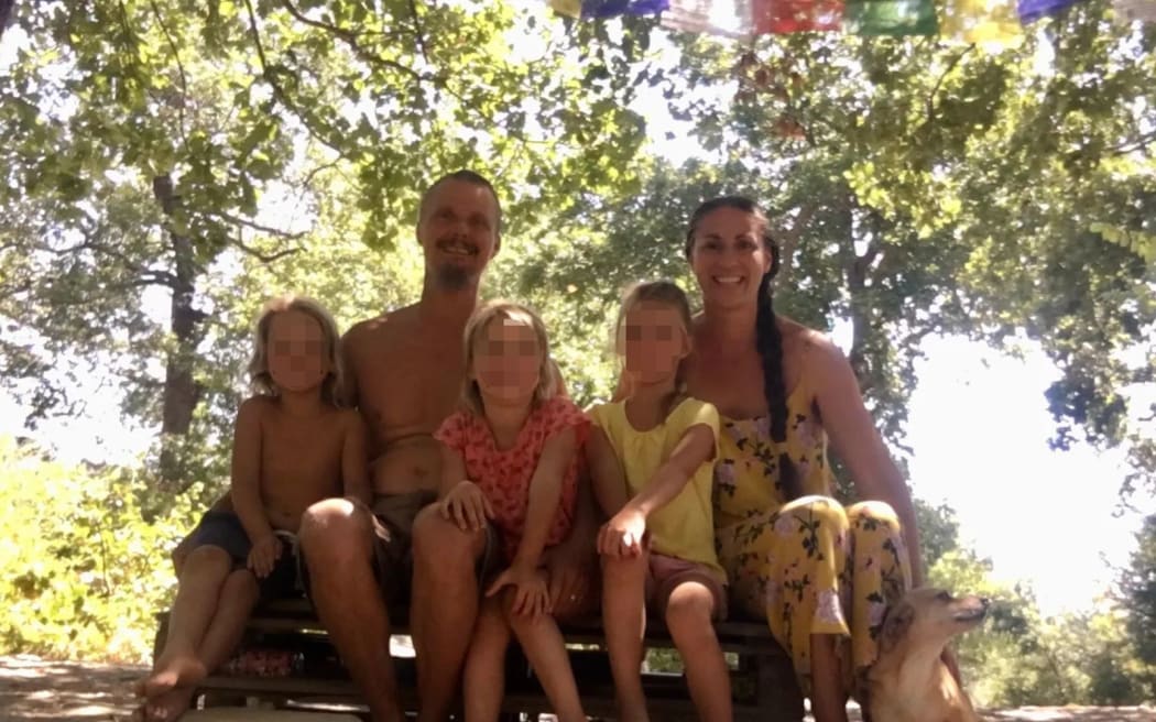 Nathan Trevallion and Catherine Birmingham pose for a picture with their children. A portion of this photo has been blurred by CNN to protect identities.
