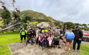Hapū members occupying the section at 1 Wharo Way in Ahipara with leader Rueben Taipari at right and the surviving half of the pōhutukawa at left.