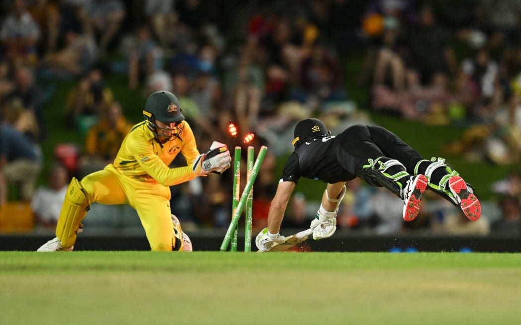 Tom Latham of New Zealand dives for his crease as Australia’s wicketkeepr Alex Carey stumps him, Chappell-Hadlee series 2022.