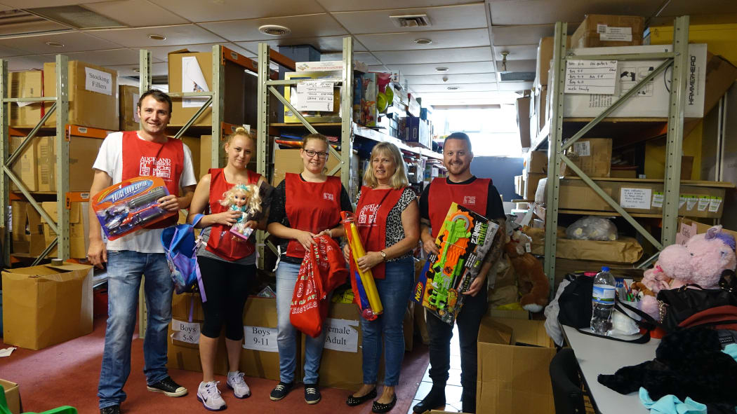 Volunteers sorting through Christmas gifts at the Auckland City Mission.