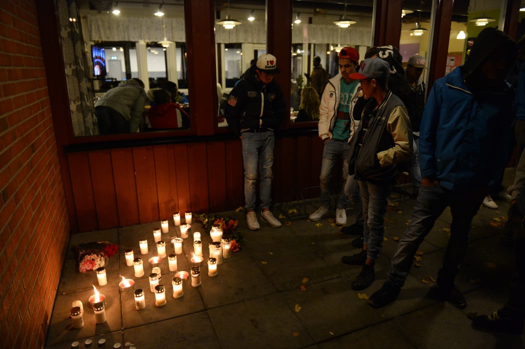 Mourners place candles outside the school.